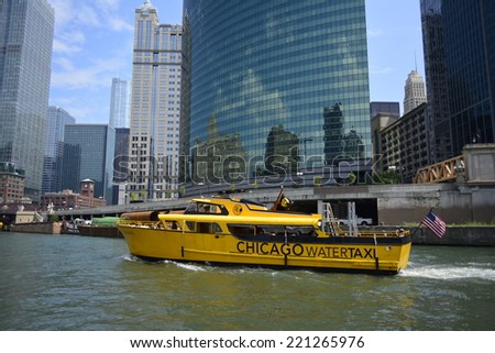 CHICAGO - AUGUST 9: A yellow watertaxi boat carries passengers from one stop to another along the Chicago River on August 9, 2014 in Chicago, Illinois USA.