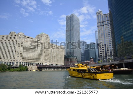 CHICAGO - AUGUST 9: A yellow watertaxi boat carries passengers from one stop to another along the Chicago River on August 9, 2014 in Chicago, Illinois.