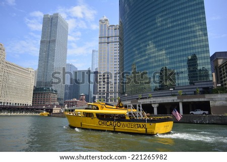 CHICAGO - AUGUST 9: A yellow watertaxi boat carries passengers from one stop to another along the Chicago River on August 9, 2014 in Chicago, Illinois.