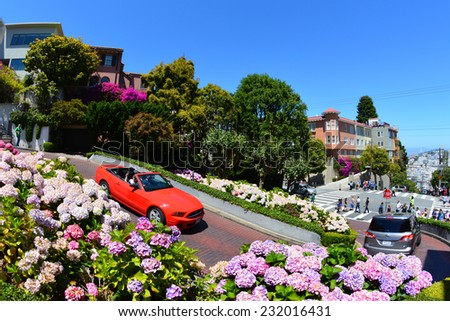 SAN FRANCISCO - JULY 13: Cars travel down Lombard Street on July 13, 2013 in San Francisco, CA. Lombard Street is famous for its eight consecutive hairpin turns.