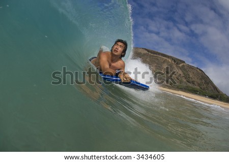 body boarder in the tube of the wave in contest