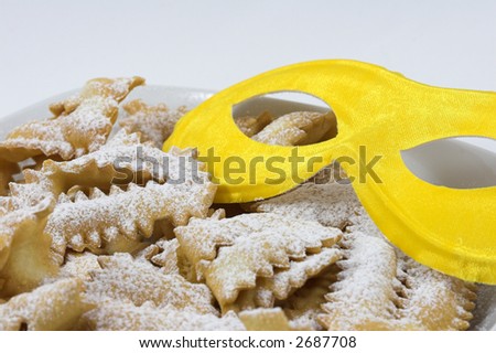 italian carnival sweet food with yellow mask