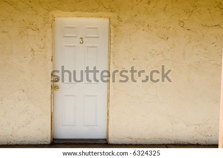 Door Number 3 offset on an off-white wall