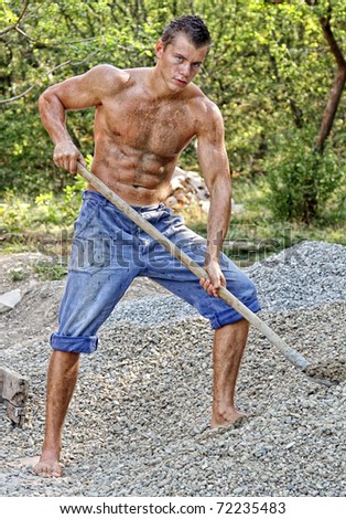 Muscular Man Showing Muscles On Wall Background. Strong 