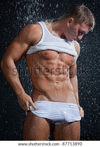 stock photo Muscle wet sexy young naked boy in white trunks and vest 