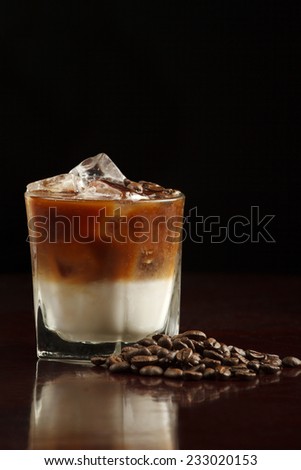 White Russian made with vodka, coffee liqueur and cream. Coffee beans garnish