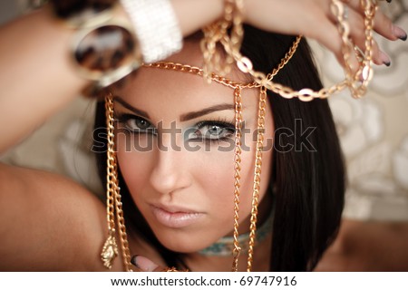 stock photo Close up of a gorgeous lady with a golden chains on her hand