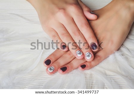 Violet nail art with printed white bow on light background