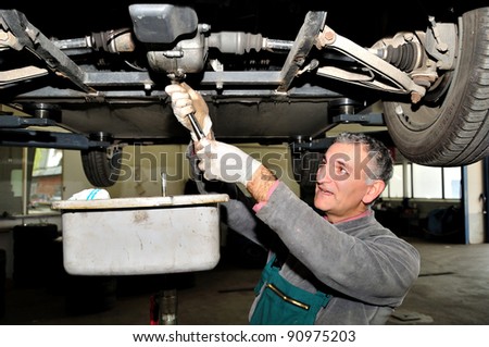 Mechanic changing engine oil.