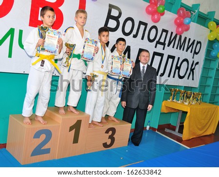 KOTSYUBYNSKE, UKRAINE - SEPTEMBER 3:  Unknown boys take the reward on the youth judo competition on September 3, 2013 in Kotsyubynske, Ukraine.