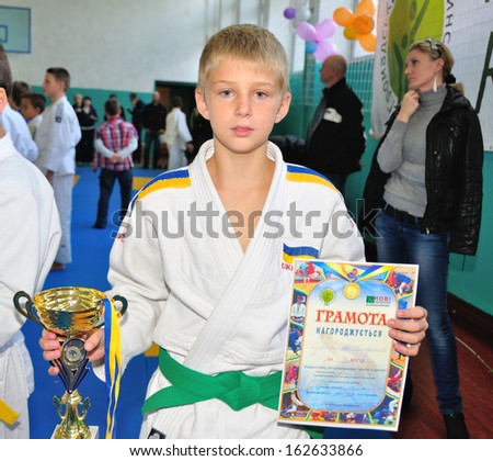 KOTSYUBYNSKE, UKRAINE - SEPTEMBER 3:  Unknown boy takes the reward on the youth judo competition on September 3, 2013 in Kotsyubynske, Ukraine.