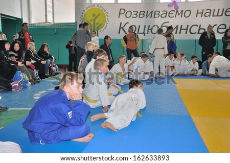 KOTSYUBYNSKE, UKRAINE - SEPTEMBER 3: Unknown boys watch the fight on the youth judo competition on September 3, 2013 in Kotsyubynske, Ukraine.