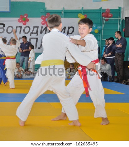 KOTSYUBYNSKE, UKRAINE - SEPTEMBER 3: Unknown boys make the duel fight on the youth judo competition on September 3, 2013 in Kotsyubynske, Ukraine.