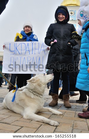 KIEV, UKRAINE Ã¢Â?Â? 30 NOVEMBER 2013: Unknown demonstrators with dog stage a strike with poster Ã¢Â?Â?Ukraine get upÃ¢Â?Â� after dispersal of proeuropean meeting on November 30, 2013 in Kiev, Ukraine.