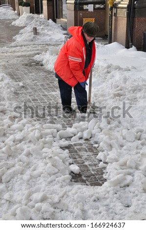 KIEV, UKRAINE Ã¢Â?Â? CIRCA MARCH 2013: Unknown street cleaner cleans streets of the city from snow captivity after snowstorm circa March 2013 in Kiev, Ukraine.