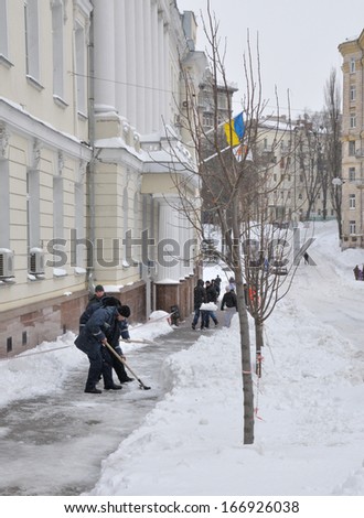 KIEV, UKRAINE Ã¢Â?Â? CIRCA MARCH 2013: Unknown street cleaners cleans streets from snow captivity after snowstorm circa March 2013 in Kiev, Ukraine.