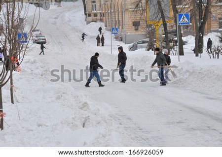 KIEV, UKRAINE Ã¢Â?Â? CIRCA MARCH 2013: Unknown street cleaners cleans streets from snow captivity after snowstorm circa March 2013 in Kiev, Ukraine.