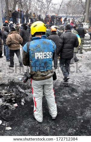 KIEV, UKRAINE Ã¢Â?Â? 22 JANUARY 2014: Unknown journalist works during a fight with police in government district on January 22, 2014 in Kiev, Ukraine.