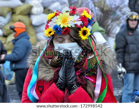 Kiev, Ukraine - 24 January 2014: Unknown Girl Prays For Peace During Street Fight With Police In Government District On January 24, 2014 In Kiev, Ukraine.