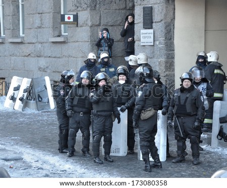 KIEV, UKRAINE - JANUARY 24, 2014: Unknown policemen rest after attack during street fights on January 24, 2014 in Kiev, Ukraine.