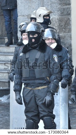KIEV, UKRAINE -  JANUARY 24, 2014: Unknown policemen rest after attack during street fights on January 24, 2014 in Kiev, Ukraine.