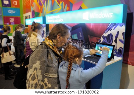 KIEV, UKRAINE - CIRCA APRIL 2014: Unknown children test gadgets on the art and book exhibition in Arsenal museum on April 2014 in Kiev, Ukraine