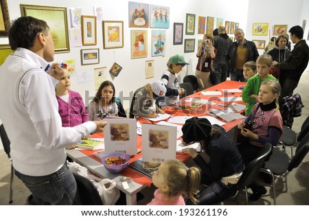 KIEV, UKRAINE - CIRCA APRIL 2014: Unknown children study useful arts on the art master-class on the art and book exhibition in Arsenal museum on April 2014 in Kiev, Ukraine
