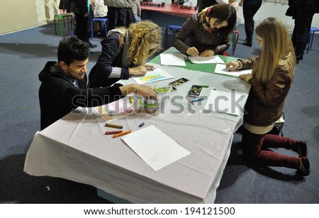 KIEV, UKRAINE - CIRCA APRIL 2014: Unknown people study useful arts on the art master-class on the art and book exhibition in Arsenal museum circa April 2014 in Kiev, Ukraine