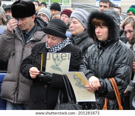 KIEV, UKRAINE - CIRCA FEBRUARY 2014: Unknown people cry on a requiem mass by died people during Ukrainian revolution on February 2014 in Kiev, Ukraine.