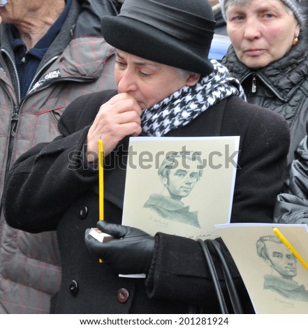 KIEV, UKRAINE - CIRCA FEBRUARY 2014: Unknown people cry on a requiem mass by died people during Ukrainian revolution on February 2014 in Kiev, Ukraine.
