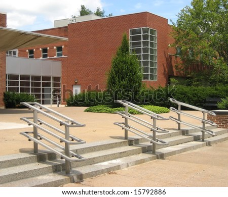 University building brick facade with steps and front walkway.