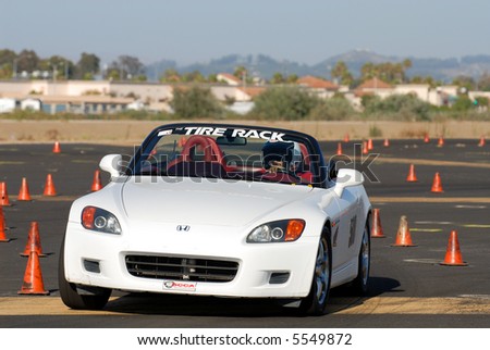 white Honda sports car competing in auto cross race