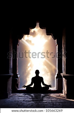 Yoga Meditation In Lotus Pose By Man Silhouette In Old Temple Arch At Dramatic Sky Background. Free Space For Text