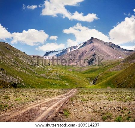 Road in mountains at blue sky in Kazakhstan, central Asia