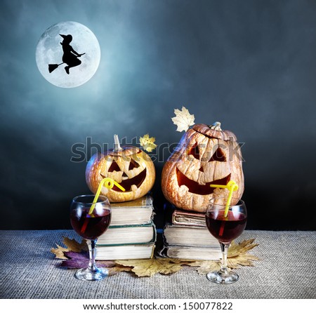 Halloween pumpkins drinking wine on the heap of books and witch silhouette on the broom flying near the full moon at dark background
