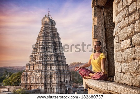 Woman doing meditation near Virupaksha temple in Hampi, Karnataka, India