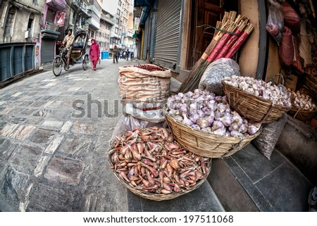 THAMEL, KATHMANDU, NEPAL - APRIL 27, 2014: Basket with garlic and chili at street shop of Thamel