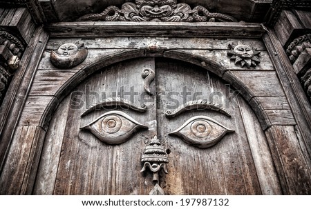 Wooden door with eyes at king palace museum on Durbar square in Kathmandu, Nepal