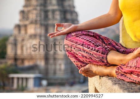 Woman doing meditation near Virupaksha temple in Hampi, Karnataka, India