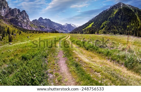 Road in Mountain valley at blue sky in Dzungarian Alatau, Kazakhstan, Central Asia