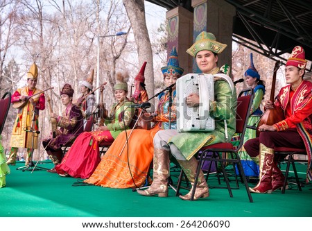 ALMATY, KAZAKHSTAN - MARCH 22, 2015: Musicians in Kazakh traditional costumes with national instruments on the stage at Nauryz celebration