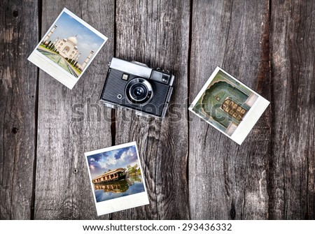 Old film camera and polaroid photos with Indian famous landmarks on the wooden background
