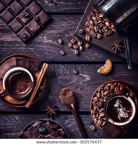 Coffee and dark chocolate with spices on the dark wooden table