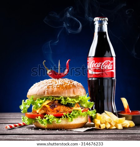 MUMBAI, INDIA  MAY 23, 2015: Illustrative editorial veggie burger, French fries and Coca-Cola bottle - is the most popular carbonated soft drink beverages sold around the world