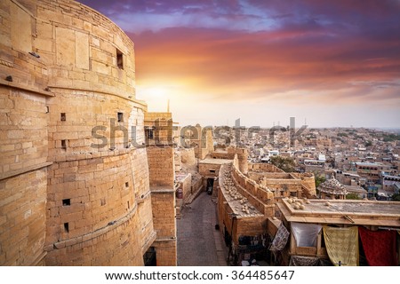 Purple sunset at sandstone desert city with Jaisalmer fort in Rajasthan, India