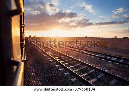 Train passing desert area at sunset sky beckgroung in Rajasthan, India