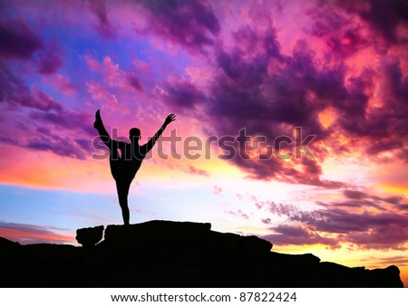 Yoga utthita Hasta Padangustasana balance pose by man silhouette with purple dramatic sunset sky background. Free space for text and can be used as template for web-site