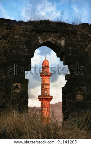Ancient Daulatabad fort with view on red tower with dramatic sky in Aurangabad, Maharashtra, India