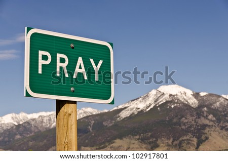 Sign for the town of Pray, Montana.  Use it for religious or spiritual themes.