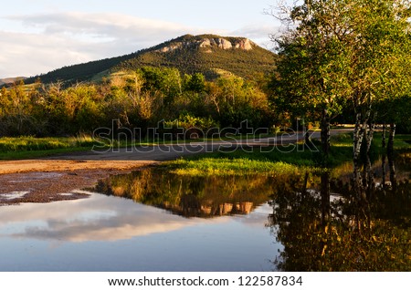 Mount Helena can be seen from many parts of Helena, Montana.  This reflection is not a normal one as it occurred because of a bit of spring flooding.